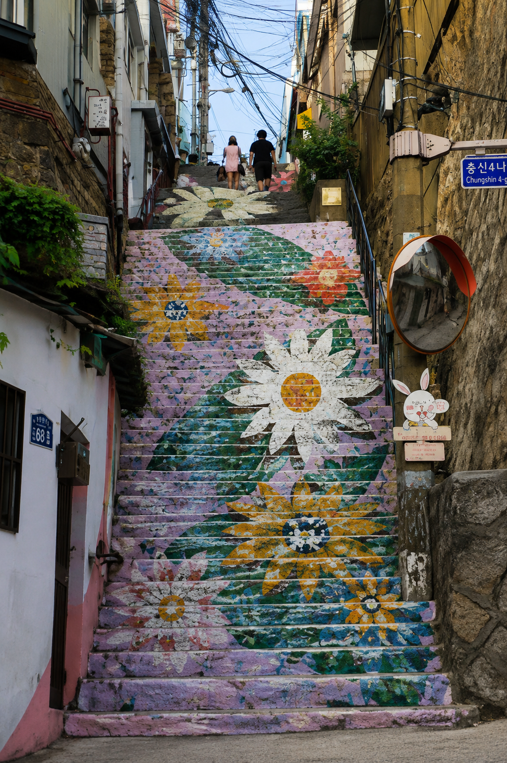 A flower-mural staircase alley in Ihwa Mural Village, Seoul