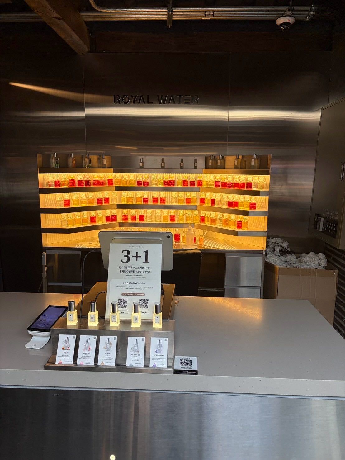 The Royal Water checkout counter with a 3+1 promotion sign