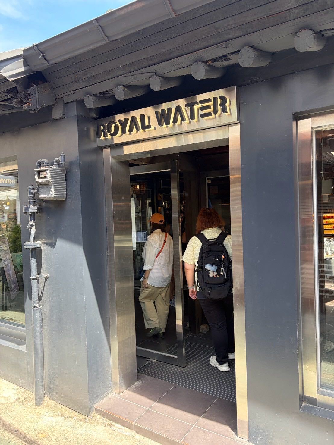 The Royal Water storefront entrance in Ikseon-dong, sign lit up above the doorway