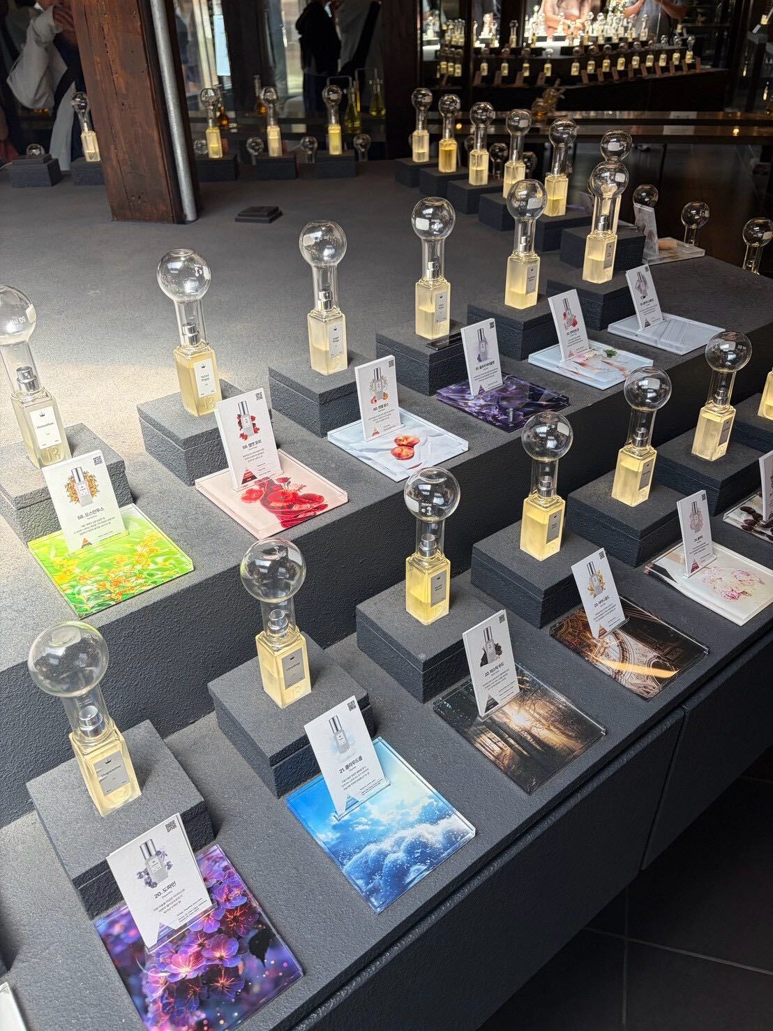 Rows of Royal Water perfume bottles on display pedestals for sampling