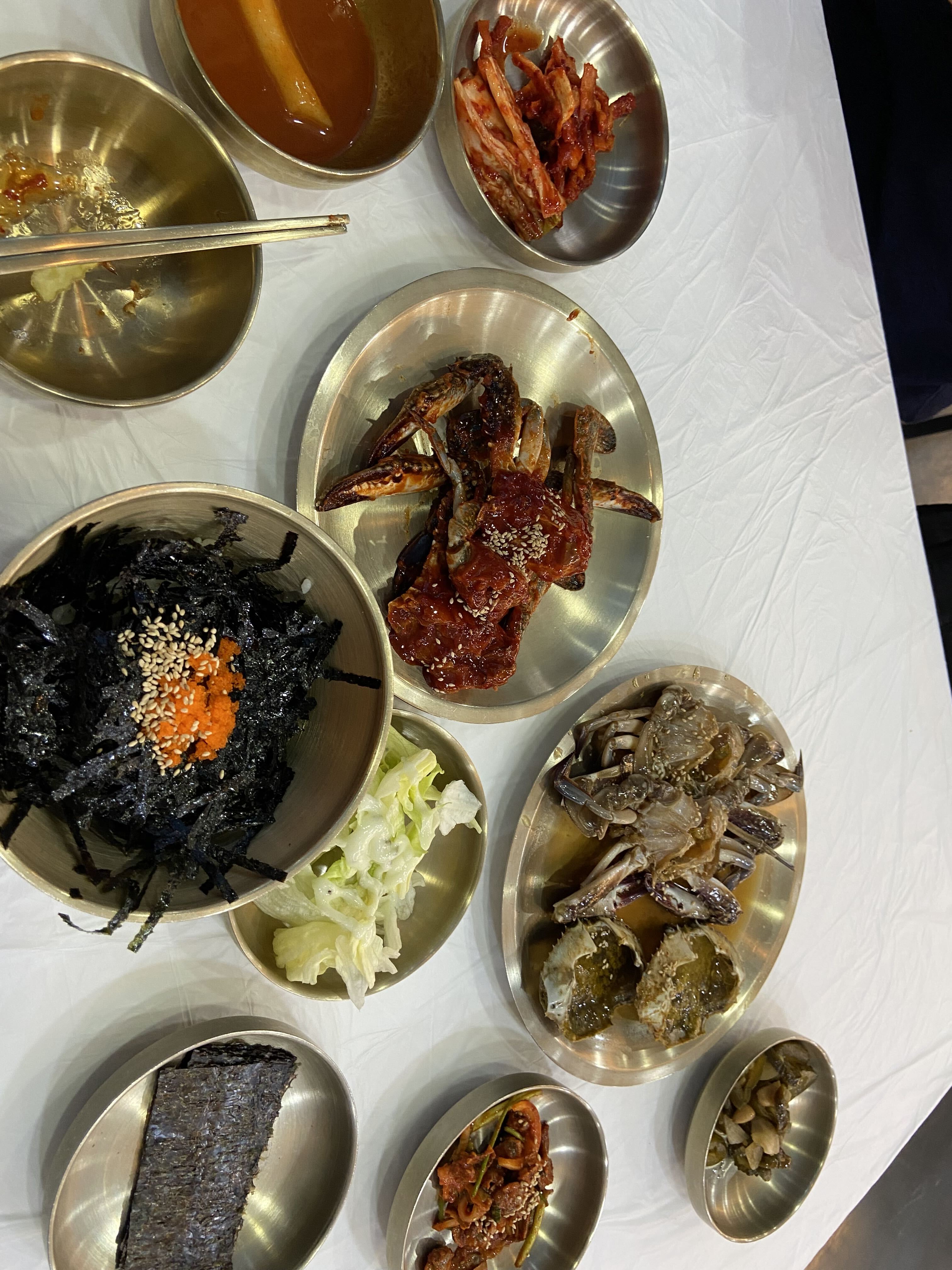 Soy-marinated crab and spicy marinated crab served with Korean side dishes