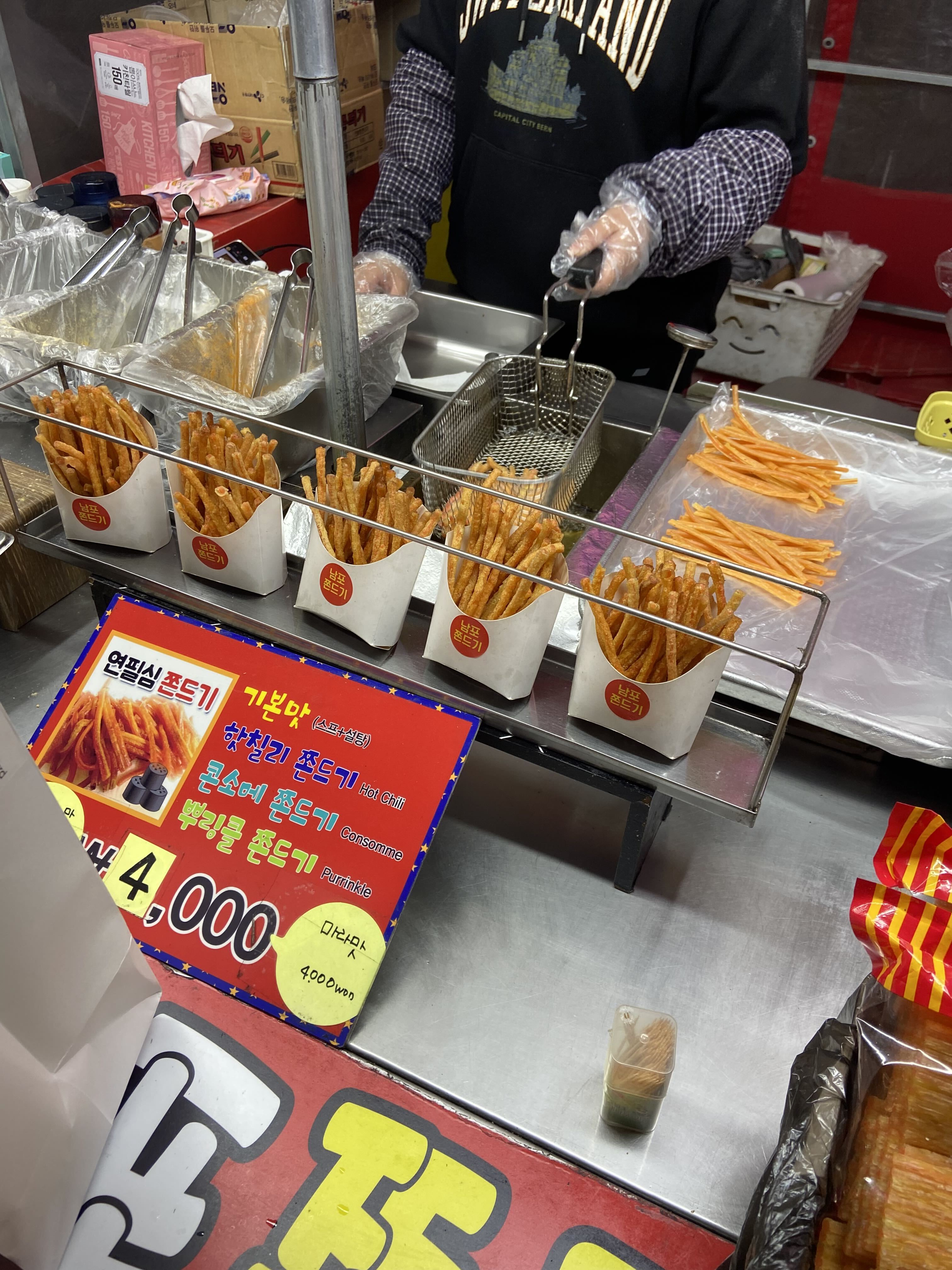 A Korean street-food stall selling cups of seasoned jjondeugi snack sticks