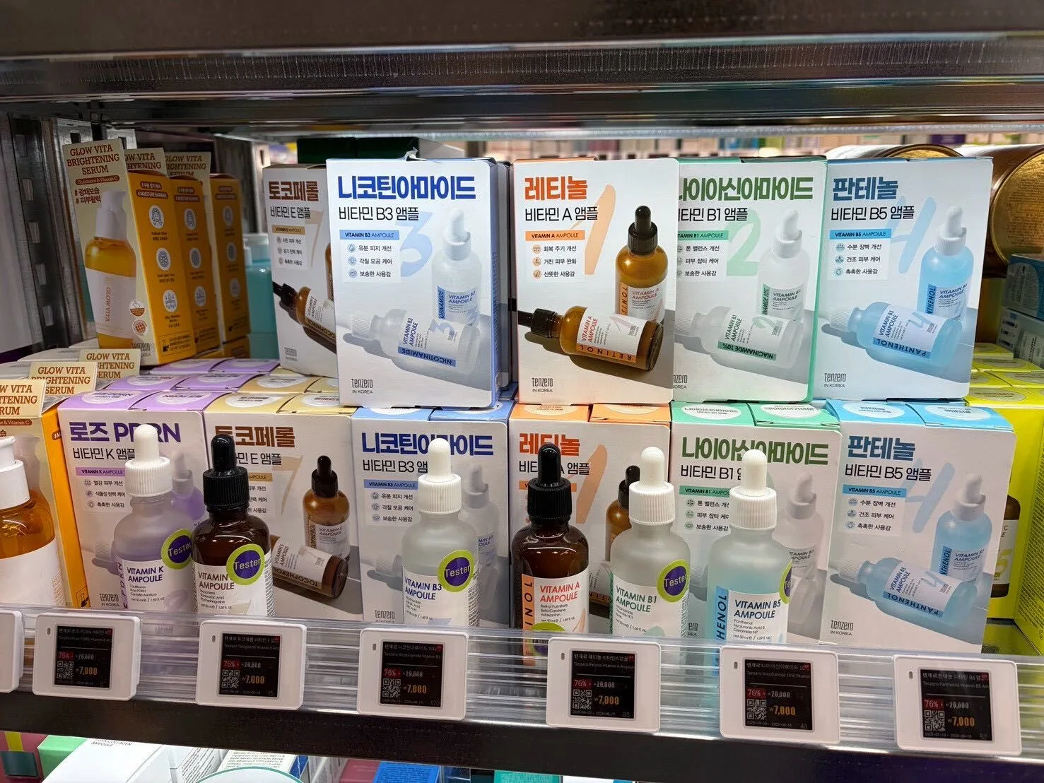 A shelf of vitamin ampoules at Off Beauty — niacinamide, retinol, and panthenol serums — each tagged with a 76% discount bringing the price down to ₩7,000