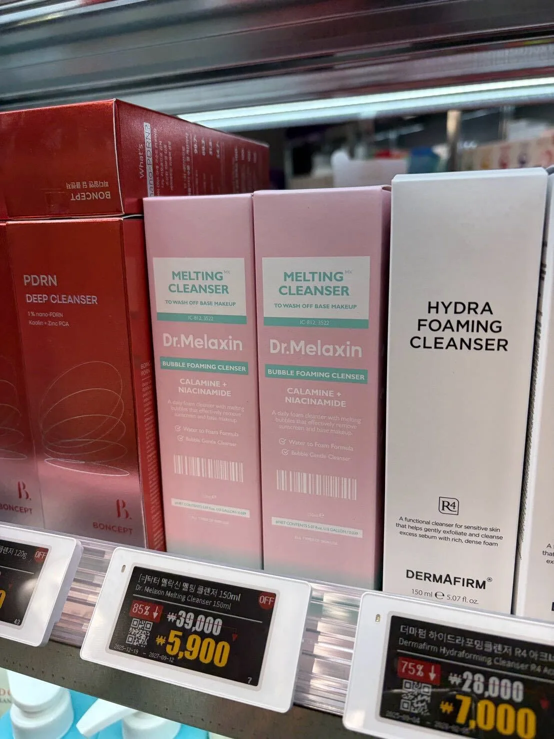 Dr. Melaxin Melting Cleanser and Dermafirm Hydra Foaming Cleanser on an Off Beauty shelf, tagged at 85% and 75% off