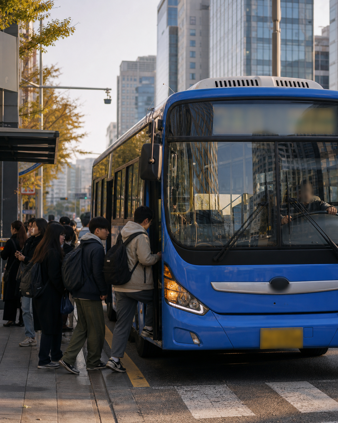 Passengers boarding a blue city bus in Seoul