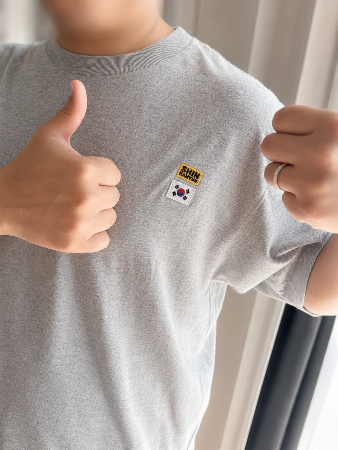 Wearing the customized Shin Ramyun T-shirt with the patches on the chest