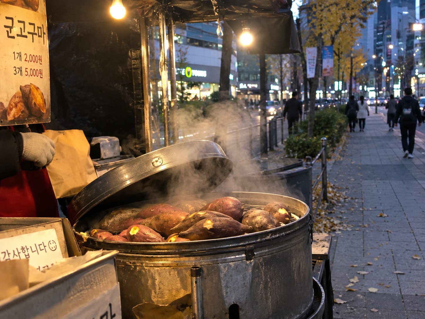 A street vendor's cart selling roasted sweet potatoes and chestnuts on a cool autumn evening in Korea